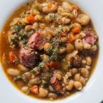 white bean stew with ham hocks in a bowl