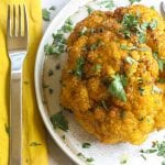 whole smoked cauliflower on a plate
