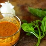jar of roasted red pepper sauce with basil and garlic on a cutting board #redpepper #sauce www.foodfidelity.com