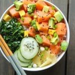 salmon poke bowl with cucumbrs, collard green salad, avocado, pickled beets and ginger