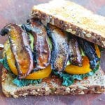 Vegan BLT Sandwich with mushroom slices with yellow tomatoes and black kale on two slices of bread