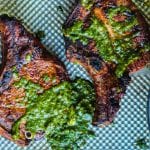 grilled puerto rican pork chops topped with chimichurri sauce