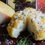 whole roasted cauliflower topped with parmigiano reggiano cheese.